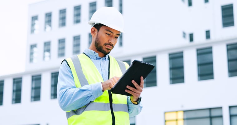 contractor looking at a digital tablet on site