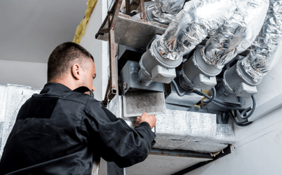 hvac technician working on hvac unit