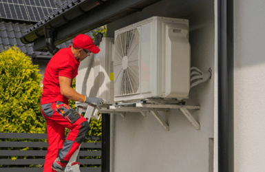 hvac professional working on an ac unit