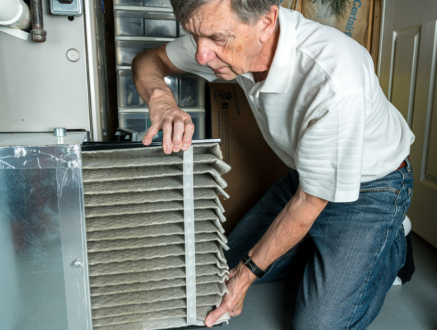 HVAC professional replacing an air filter